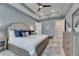 Bedroom featuring a tray ceiling, ensuite bathroom, and light-colored walls at 7420 Paradiso Dr, Apollo Beach, FL 33572