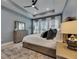 Bedroom with tray ceiling, plantation shutters, light walls, and wood dresser at 7420 Paradiso Dr, Apollo Beach, FL 33572