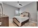 Cozy bedroom with a ceiling fan, dresser, and plantation shutters at 7420 Paradiso Dr, Apollo Beach, FL 33572