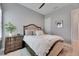 Bedroom featuring a bed with light colored bedding, wood nightstand, and light gray walls at 7420 Paradiso Dr, Apollo Beach, FL 33572