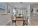 Bright and open dining area featuring plantation shutters and views of the outdoor scenery and stylish decor at 7420 Paradiso Dr, Apollo Beach, FL 33572