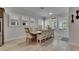 Bright dining area featuring ample natural light, wooden flooring, and stylish table for Gathering dining and entertaining at 7420 Paradiso Dr, Apollo Beach, FL 33572