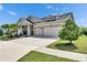 Charming two-story home featuring a three car garage, well-manicured lawn, and inviting curb appeal at 7420 Paradiso Dr, Apollo Beach, FL 33572