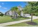 Charming single-story home featuring a well-manicured lawn, tropical landscaping, and inviting curb appeal at 7420 Paradiso Dr, Apollo Beach, FL 33572