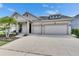 Attractive home with a two-car garage, palm trees, a manicured lawn, and a cozy front porch at 7420 Paradiso Dr, Apollo Beach, FL 33572