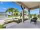 Relaxing front porch with comfortable chairs, well-kept landscaping, and a view of the neighborhood at 7420 Paradiso Dr, Apollo Beach, FL 33572