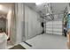 Spacious garage featuring a clean, finished floor, organization racks and partial curtain at 7420 Paradiso Dr, Apollo Beach, FL 33572