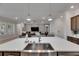 Open-concept living space features a large island, stainless sink, and a view of the Gathering room at 7420 Paradiso Dr, Apollo Beach, FL 33572