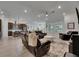 Spacious living room with brown leather seating, neutral color palette, and abundant natural light from large windows at 7420 Paradiso Dr, Apollo Beach, FL 33572