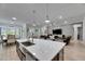 Open-concept living space features a large island, stainless sink, and a view of the Gathering room at 7420 Paradiso Dr, Apollo Beach, FL 33572