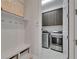Convenient mudroom with built-in bench, coat hooks, and access to the laundry room at 7420 Paradiso Dr, Apollo Beach, FL 33572