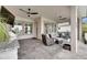 Covered patio with ceiling fans, outdoor kitchen, fire pit and furniture creating a relaxing outdoor living space at 7420 Paradiso Dr, Apollo Beach, FL 33572