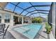 Enclosed pool with step-in entry and lounge chairs, perfect for relaxing in a private outdoor setting at 7420 Paradiso Dr, Apollo Beach, FL 33572