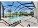Enclosed pool area offering a private oasis, complete with lounge chairs and dining under an umbrella at 7420 Paradiso Dr, Apollo Beach, FL 33572