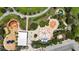 Aerial view of the community splash pad and playground with parking and walkways lined by lush greenery at 7420 Paradiso Dr, Apollo Beach, FL 33572