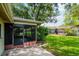 Backyard showing the screened porch, landscaping and nice sized yard at 8626 Woodbridge Dr, New Port Richey, FL 34655