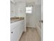Bathroom featuring white vanity, granite countertop, and shower-tub combination at 8626 Woodbridge Dr, New Port Richey, FL 34655