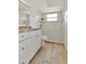 Bright bathroom with white vanity, updated countertops, and tiled shower with glass door at 8626 Woodbridge Dr, New Port Richey, FL 34655