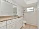 Bright bathroom with white vanity, updated countertops, and tiled shower with glass door at 8626 Woodbridge Dr, New Port Richey, FL 34655