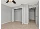Bedroom with closet, neutral walls, and tiled flooring at 8626 Woodbridge Dr, New Port Richey, FL 34655