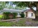 Charming single-story home showcasing stone and wood accents plus lush landscaping enhancing its curb appeal at 8626 Woodbridge Dr, New Port Richey, FL 34655