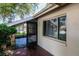 Exterior view of the home featuring a screened porch and nearby window at 8626 Woodbridge Dr, New Port Richey, FL 34655