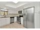 Kitchen showcasing stainless steel appliances, white cabinets, and a window with natural light at 8626 Woodbridge Dr, New Port Richey, FL 34655
