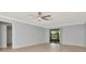 Inviting living room with ceiling fan and sliding glass door at 8626 Woodbridge Dr, New Port Richey, FL 34655