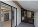 View of the kitchen through sliding glass doors from the screened porch area at 8626 Woodbridge Dr, New Port Richey, FL 34655