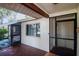Enclosed porch area with screens and access to the front entrance and an interior door at 8626 Woodbridge Dr, New Port Richey, FL 34655