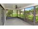 View of this screened porch with ceiling fan looking out to backyard landscaping at 8626 Woodbridge Dr, New Port Richey, FL 34655