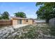 Fenced in backyard with lawn and mature trees at 8804 Lido Ln, Port Richey, FL 34668