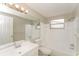 Bright bathroom featuring a shower-tub combo, window and vanity at 8804 Lido Ln, Port Richey, FL 34668