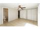 Comfortable bedroom with tile flooring, closet space, and a ceiling fan at 8804 Lido Ln, Port Richey, FL 34668