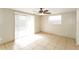 Bright bedroom featuring sliding glass doors and tile floors, offering natural light and easy access at 8804 Lido Ln, Port Richey, FL 34668