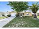 Charming single-story home with a well-manicured lawn and mature trees at 8804 Lido Ln, Port Richey, FL 34668