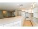 Bright, updated kitchen with white cabinets, countertops, and stainless steel appliances at 8804 Lido Ln, Port Richey, FL 34668