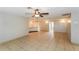 Spacious living room featuring tile flooring and a ceiling fan at 8804 Lido Ln, Port Richey, FL 34668