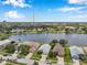An aerial view shows homes nestled around a lake with a distant skyline at 899 Addison Ne Dr, St Petersburg, FL 33716