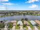 Aerial view of homes nestled around a picturesque lake with a city skyline backdrop at 899 Addison Ne Dr, St Petersburg, FL 33716