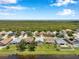 Scenic aerial view of a residential area near a lake, featuring lush greenery and a glimpse of the sea at 899 Addison Ne Dr, St Petersburg, FL 33716