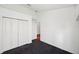A bright bedroom features plush carpeting, a spacious closet, and a neutral color palette at 899 Addison Ne Dr, St Petersburg, FL 33716