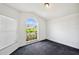 Cozy bedroom featuring vaulted ceilings and large window at 899 Addison Ne Dr, St Petersburg, FL 33716