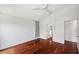 A bright bedroom boasts hardwood floors and ample natural light from an exterior window at 899 Addison Ne Dr, St Petersburg, FL 33716