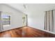 Bright bedroom with hardwood floors, two windows for plenty of natural light, and serene lake views at 899 Addison Ne Dr, St Petersburg, FL 33716
