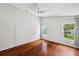 A bright bedroom features hardwood floors, two large windows and a ceiling fan at 899 Addison Ne Dr, St Petersburg, FL 33716