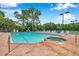 Community pool and spa with brick surround and lounge chairs on a sunny day at 899 Addison Ne Dr, St Petersburg, FL 33716