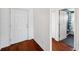 Bright entryway with hardwood floors, leading to a bathroom and other rooms in the home at 899 Addison Ne Dr, St Petersburg, FL 33716