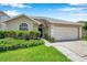 Charming single-story home with a well-manicured lawn and attached two-car garage at 899 Addison Ne Dr, St Petersburg, FL 33716