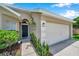 Charming single-story home with a well-manicured lawn and attached two-car garage at 899 Addison Ne Dr, St Petersburg, FL 33716